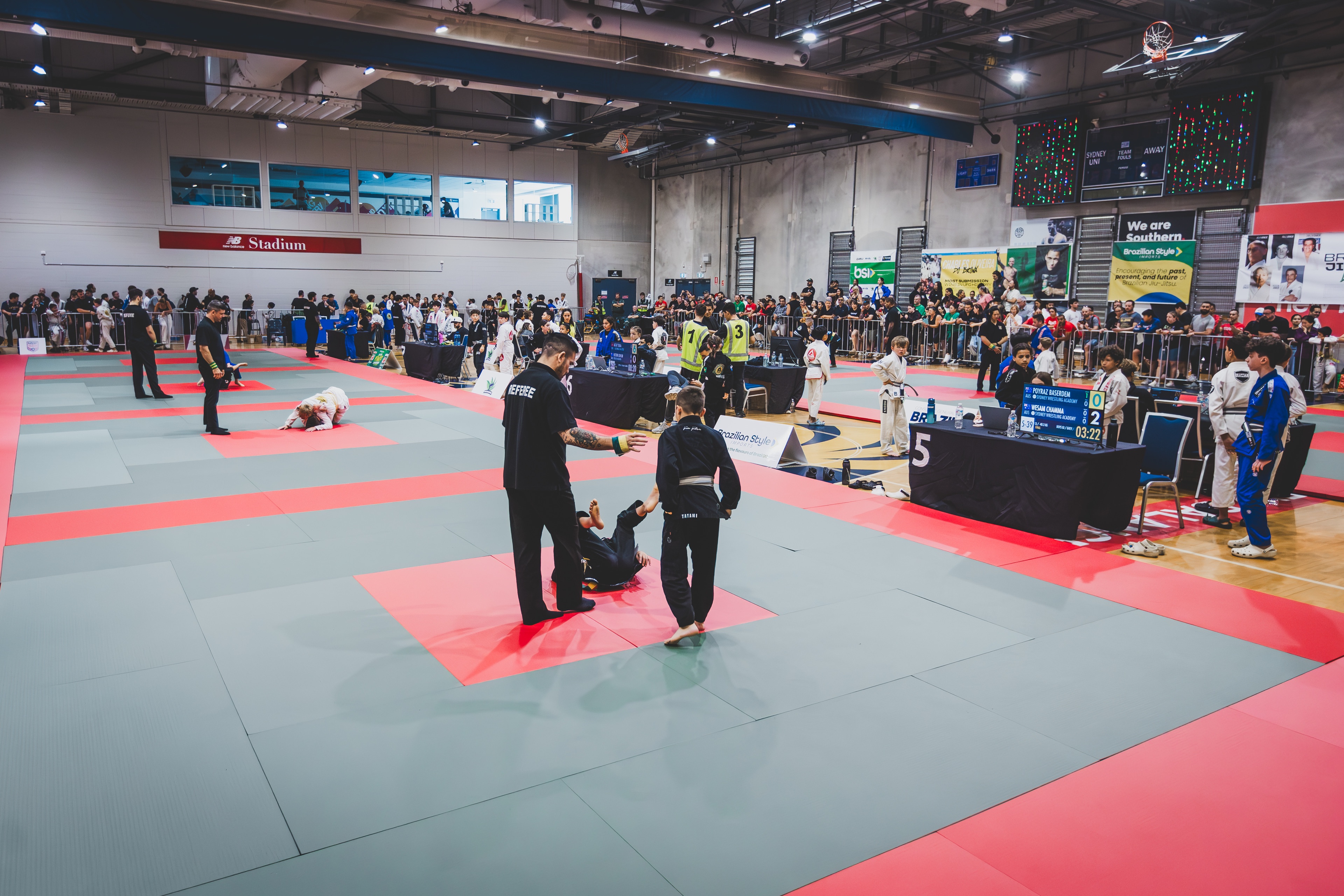ABJJA Brazilian Jiu Jitsu tournament mats with athletes and officials